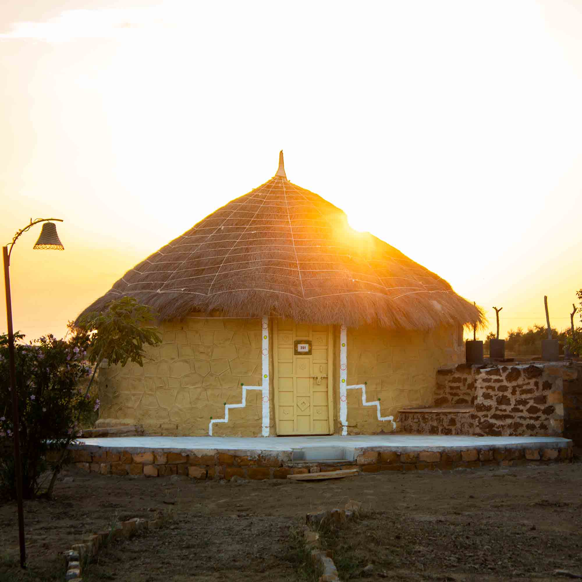 Golden sunset over an eco-friendly cottage at Dreamtime Bungalows, Kuldhara
