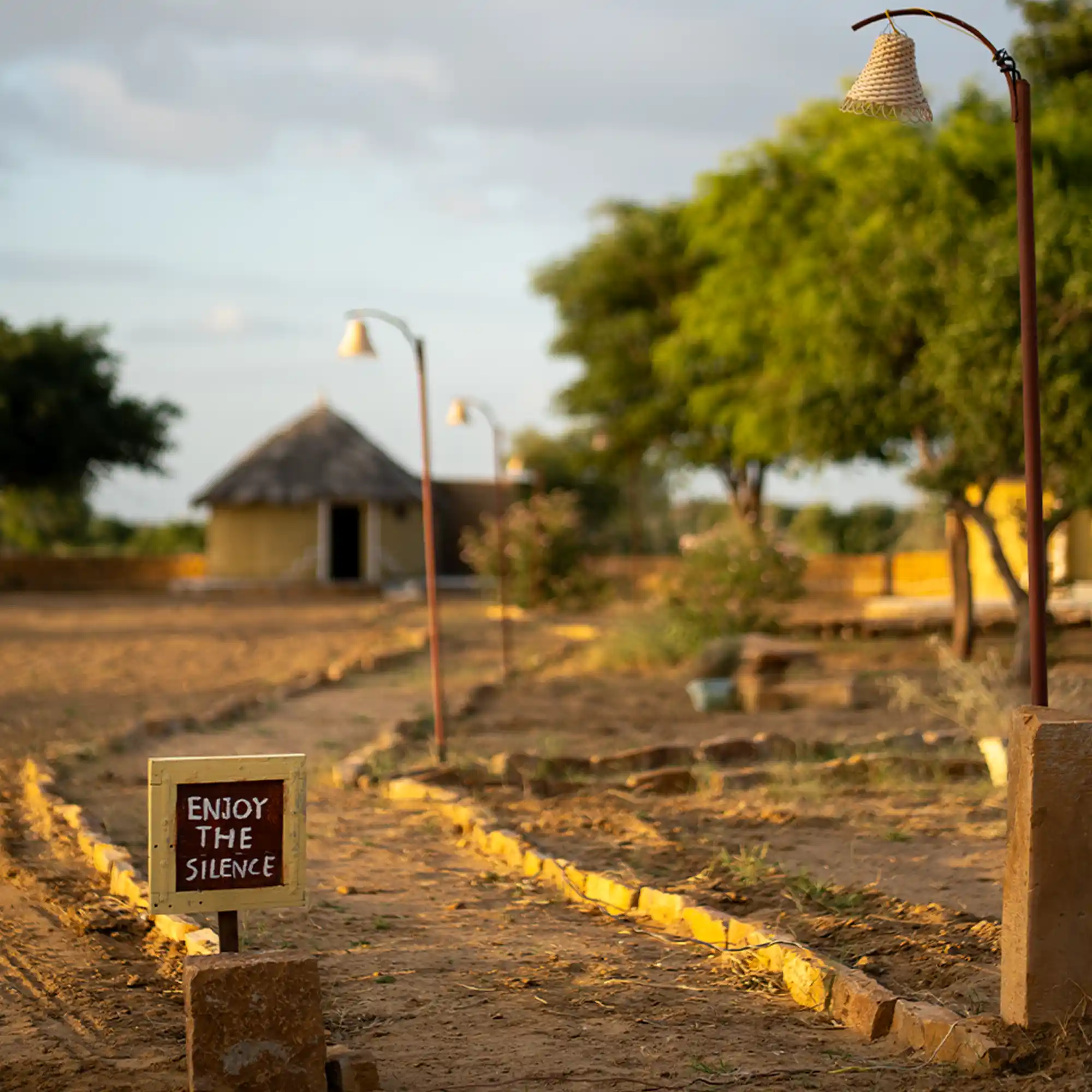 Enjoy the Silence’ sign along the pathway at Dreamtime Bungalows